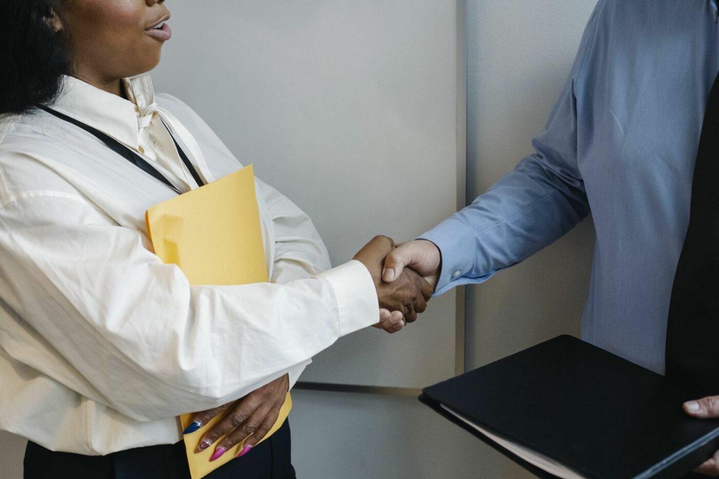 Diverse coworkers shaking hands after meeting